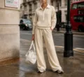 Beige half-zip sweatshirt and wide-leg trousers tracksuit set worn on London street detail. - Apricot