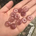 Close-up of 15mm natural strawberry quartz donut beads held in hand for jewelry making - 15mm / Strawberry Quartz