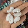 Close-up view of white natural stone comma-shaped pendants for DIY jewelry making and necklaces - 1 Piece (13*23mm) / White Jade