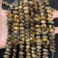 Close-up of natural Tiger Eye hexagonal prism beads for DIY jewelry making - 7x14mm (Approx. 24 Pieces/Strand) / Tiger's Eye
