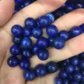 Close-up macro view of blue lapis lazuli round beads with natural golden pyrite flecks - 8mm (No Hole) / Lapis Lazuli