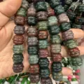 Close-up of colorful carved natural stone drum beads for DIY jewelry making - India Agate