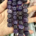 Macro detail of carved drum-shaped natural purple stone beads for DIY jewelry making - Purple Crystal