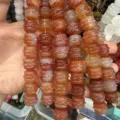 Close-up of natural agate carved drum beads in reddish brown hues - Red Agate