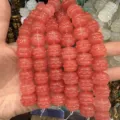 Close-up of pink carved drum-shaped natural agate beads for DIY jewelry making - Watermelon red