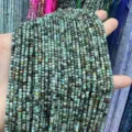 Macro detail of 2.5mm faceted square green natural stone beads for DIY jewelry making - Approx. 2.5mm (Approx. 160 Beads/Strand) / African Pine Stone