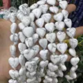 Close-up detail of white heart-shaped natural howlite stone beads for DIY jewelry making crafts - 15*15*6mm (Approx. 24 Pieces/Pack) / Natural White Turquoise
