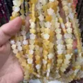 Close-up detail of 8mm star-shaped yellow agate natural stone beads for DIY jewelry - 8mm (Approx 56 Beads Per Strand) / Natural Yellow Jade