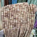 Close-up of 4x6mm natural stone abacus beads in mixed earth tones for DIY jewelry. - 90 Pieces/Pack / Dark Pink Aventurine