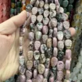 Detailed view of leaf-shaped pink rhodonite stone beads for custom jewelry design - 10x14x6 (15 Beads Per Strand) / Rhodonite