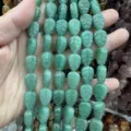 Detailed macro view showing green aventurine stone beads in carved leaf shape texture - 10x14x6 (15 Beads Per Strand) / Green Aventurine