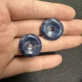 Close-up of two blue natural stone donut beads held in hand for DIY jewelry making - 10 Pieces/Pack / Blue Vein Stone