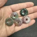 Close-up of five 20mm colorful natural stone donut beads on a hand - 10 Pieces/Pack / India Agate