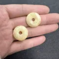 Macro view of 20mm pale yellow natural stone donut beads for DIY jewelry accessories - 10 Pieces/Pack / Beige Jade