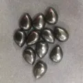 Detailed macro view of teardrop-shaped black agate cabochons with metallic luster - 4*6mm / Black Agate