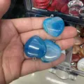 Detailed view of blue heart-shaped agate stone pendants with natural stripes - 25*6mm / Blue Agate