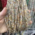 Close-up detail of 2x4mm natural stone tube beads showing various textures and earthy tones - Crazy Lace Agate (Tube) / 2*4mm (Approx. 38cm Strand)
