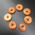 Close-up of 15mm natural orange stone Ping'an Kou donut beads for DIY jewelry making - 15mm / Red Aventurine