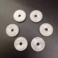 Detailed macro shot of six 15mm white translucent natural stone donut jewelry beads - 15mm / White Jade