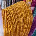 Close-up macro view of vibrant 3mm natural orange shell heishi beads for DIY jewelry making - 3mm (Approx. 39cm Per Strand) / Golden