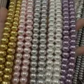 Detailed view of high-gloss colored imitation pearl abacus beads for DIY jewelry - Gold