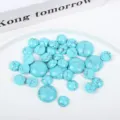 Detailed close-up of round turquoise cabochons with natural black matrix patterns for jewelry DIY. - 4mm / Turquoise