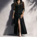 Detailed view of the black mesh spliced long sleeve denim dress featuring a high front slit. - S / Black