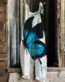 Detail view of women's cotton linen casual jumpsuit featuring a striking blue butterfly print. - S / Dresses / 026