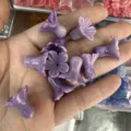 Detailed macro shot of purple shell powder pressed morning glory flower beads for DIY crafts - Two-tone Purple