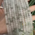 Close-up detail of light green translucent natural stone barrel beads for DIY jewelry - 5*6mm (Approx. 72 Pieces/Pack) / Tianshan Green