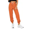 Close-up detail of women orange high waist cuffed sweatpants with white drawstring. - S / Orange