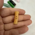 Macro detail of amber-colored natural stone bamboo button for vintage clothing - 8*20MM / Topaz