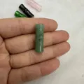 Detailed macro view of a green natural stone bamboo shaped two-hole button for clothing - 8*20MM / Green Aventurine