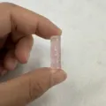 Macro detail of a pink natural stone bamboo-joint double-hole button for clothing - 8*20MM / Rose Quartz