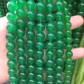 Close-up detail of smooth green chalcedony round beads for DIY jewelry making - Malaysian Jade
