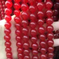 Macro view of polished red translucent chalcedony round beads for DIY jewelry making projects - 4mm Strand (Approx 93 Pieces) / Red Jade