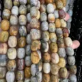 Macro detail of natural agate barrel beads with unique earth-tone textures for DIY jewelry - 10x14mm (Approx 28 Pcs/Strand) / Crazy Lace Agate