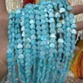 Macro detail of blue iridescent heart-shaped mother of pearl shell beads for DIY jewelry. - Vertical Hole Heart Shape / 8mm (Approx 47 Beads per Strand) / Blue