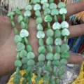 Close-up of light green heart-shaped mother of pearl beads for DIY jewelry making - Vertical Hole Heart Shape / 8mm (Approx 47 Beads per Strand) / Green