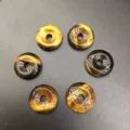 Macro view of 15mm natural tiger eye stone donut pendants for DIY jewelry making - 15mm / Tiger Eye