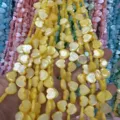Detail view of yellow mother of pearl heart beads strings for DIY jewelry designs - Horizontal Hole Heart Shape / 8mm (Approx 47 Beads per Strand) / Yellow