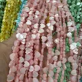 Close-up of iridescent heart-shaped mother of pearl shell beads for DIY jewelry making - Horizontal Hole Heart Shape / 8mm (Approx 47 Beads per Strand) / Pink