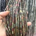 Close-up of multi-colored cylindrical natural stone beads showing earthy textures - Rectangle Strip (Length 38cm) / Picasso Stone