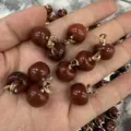 Close-up view of natural mahogany stone apple-shaped pendants for DIY jewelry making. - 15mm (ai-10 Pieces/Pack) / Mahogany Obsidian