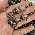 Macro view of pink and black natural stone apple pendants with elegant golden metal loops - 15mm (ai-10 Pieces/Pack) / Rhodonite with Black Lines