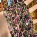 Macro detail of irregular 4x6mm natural multi-color stone beads for jewelry DIY crafting - Tourmaline