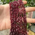 Detailed macro view of 4x6mm irregular deep red garnet-style natural stone beads for DIY jewelry - Garnet