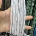 Detailed macro view of 2x2mm white natural stone cylindrical beads for DIY jewelry crafting - White Jade Cylinder / One Strand (Approx 38cm)