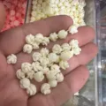 Macro detail of small cream 3D shell powder rose beads with horizontal holes for DIY jewelry - Approx. 6mm (Min. Order 100 Pcs) / Creamy White (12)