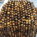 Macro detail of natural A-grade tiger's eye stone beads for DIY jewelry making - 8mm (Approx 47 Pieces/Pack) / Grade AB+ Tiger's Eye